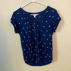 A Sonoma blue small top with flowers and shorter sleeves, and a few buttons.